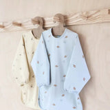 Dino Waterproof Cape Bib In Butter  OYOY   